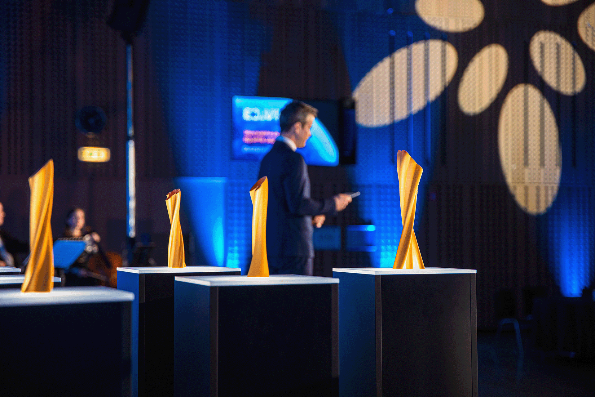 Photo of the award trophies for the ED.VITA national sustainability in education award on the stage at the event ceremony.